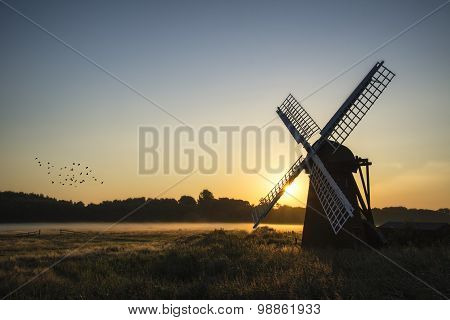 Old Windmill In Foggy Countryside Landscape In England