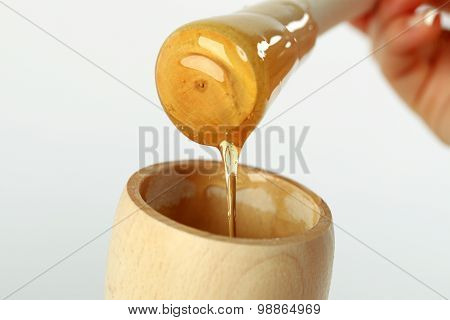 Honey Dipper On The Bee Honeycomb Background. Honey Tidbit In Glass Jar And Honeycombs Wax.