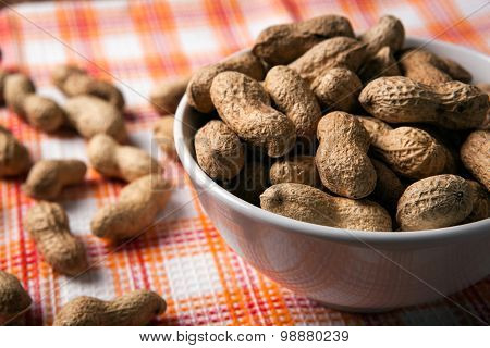 Large Grains Of Peanuts In The Shell And The Bowl