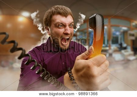 Angry man speaks on the phone