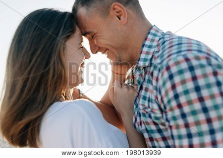The guy and the girl having touched with foreheads smtsya, a close up