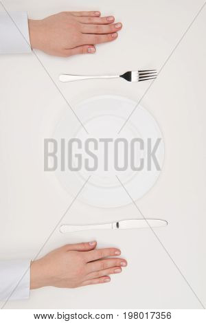 Hands, Empty Plate And Cutlery