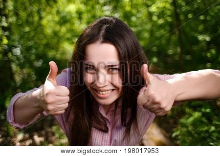 Portrait Of Young Excited Woman With Thumbs Up