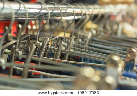 Many hangers in a row for clothes in the store