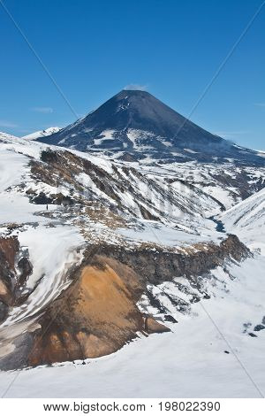 Karymsky volcano on the Kamchatka Peninsula. The views of the working Karymsky volcano in may 2016 photo from a helicopter. Russia