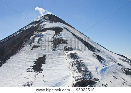 A view of the current cone of Karymsky volcano from a helicopter in may 2016 on the Kamchatka Peninsula. Russia