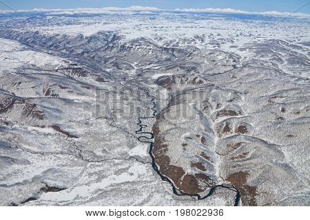 Views of the foothills of the Karymsky volcano from a helicopter after a spring snowfall on the Kamchatka Peninsula. Russia