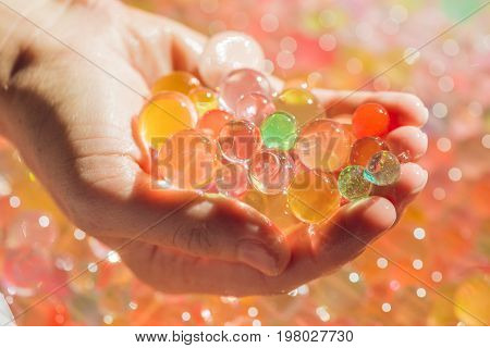 Colored Balls Of Water Beads, Hydrogel In In Hands. Sensory Experiences