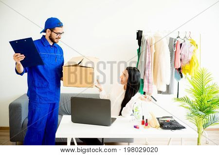 Woman accepting a box package from deliveryman