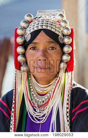 Chiang Rai, Thailand - February 8, 2017: Portrait of an unidentified Akha woman with traditional clothes and silver jewelery in Akha hilltribe village in Northern Thailand