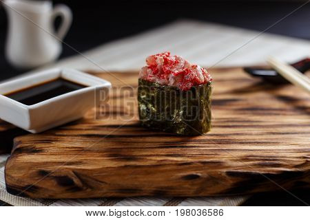 Nigiri Sushi With Spicy Salmon And Caviar, Served On Wooden Rust