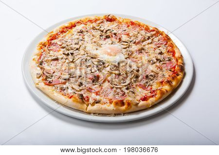 Italy Pizza With Egg Yolk Ham Mushrooms On A White Background