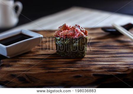 Nigiri Sushi With Spicy Smoked Eel And Caviar, Served On Wooden