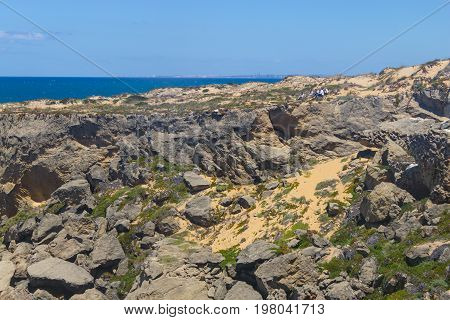 Group Resting Over The Cliffs On The Beach,  Vila Nova De Milfontes