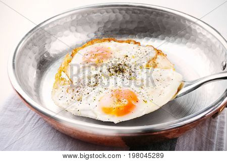Pan with over hard fried eggs, closeup