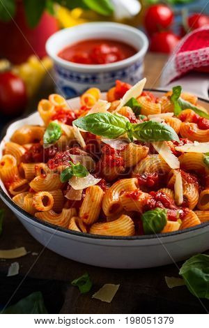 Pasta with spicy tomato sauce, parmesan and basil. Pasta Chifferi Rigati.