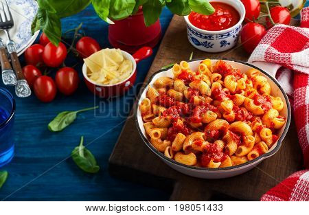 Pasta with spicy tomato sauce, parmesan and basil. Pasta Chifferi Rigati.