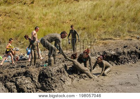 Kuchugury, Russia - July 16, 2017: Azov scorching heat mud volcano. People take procedures with healing mud