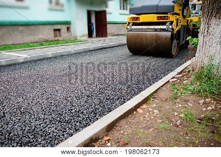 Background Of Asphalt Roller That Stack And Press Hot Asphalt. Road Repair Machine