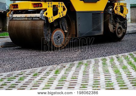 Background Of Asphalt Roller That Stack And Press Hot Asphalt. Road Repair Machine