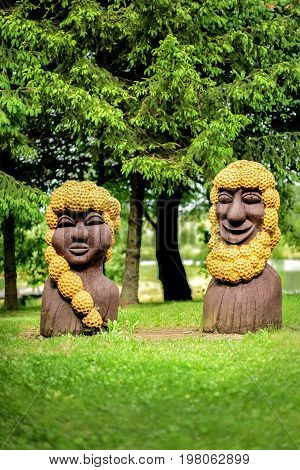 Lithuania, Vilnius - JUNE 20, 2017. National wooden statues in the garden on the lake shore