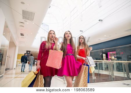 Beautiful girls with shopping bags walking at the mall