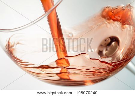 Wine splashing on glass isolated on white background