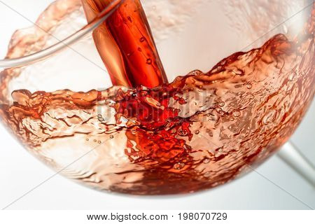 Wine splashing on glass isolated on white background