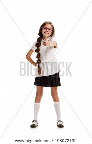 Full portrait of happy young schoolgirl showing thumb up