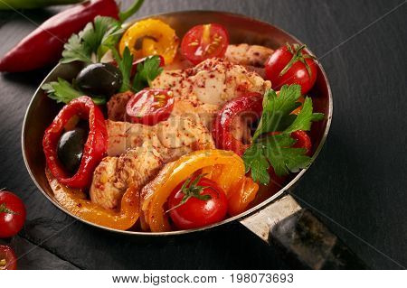 Fried chicken with vegetables on the pan and Italian pasta with a parmesan cheese basil olives paprica and tomatoes on a plate. Healthy food copncept. Top view copy space.