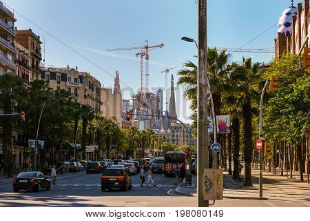 BARCELONA, SPAIN - MAY 2017: Street traffic at Barcelona town with Sagrada Familia on a background, Spain