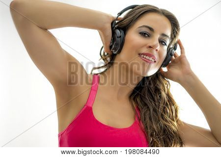 Lifestyle, Brunette girl with inline skates, dressed in sports clothes and headphones on the head