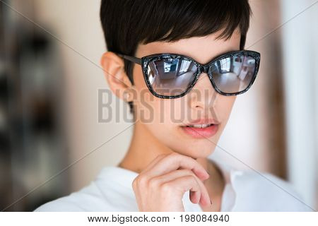 Portrait of eautiful young perfect model posing in fashion sunglasses