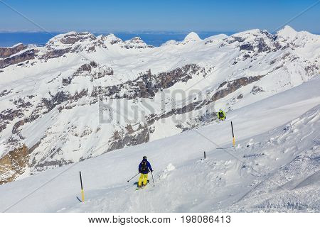 Mt. Titlis, Switzerland - 9 March, 2016: people skiing on Mt. Titlis. The Titlis is a mountain located on the border between the Swiss cantons of Obwalden and Bern, mainly accessed from the town of Engelberg on the northern side.