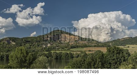 Quarry On Hill Near Libochovany Village And River Labe With Big White Clouds
