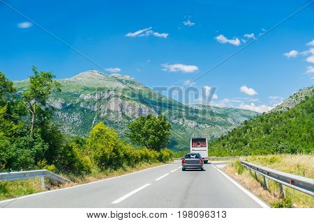 Tourists Travel Around Montenegro In A Rented Car Or By Bus.