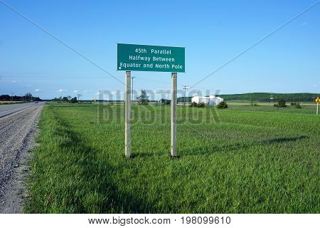 A sign on Highway 131, near Alba, Michigan, marks the 45th parallel, half-way between the equator and the north pole.