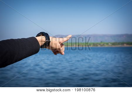 Woman Finger Pointing To The Mountain. Tourism Concept.