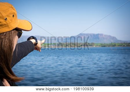 Woman Finger Pointing To The Mountain. Tourism Concept.