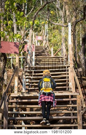 Tourist Young Woman Wearing Hat Enjoying The Walk Up The Stairs On The Mountain.