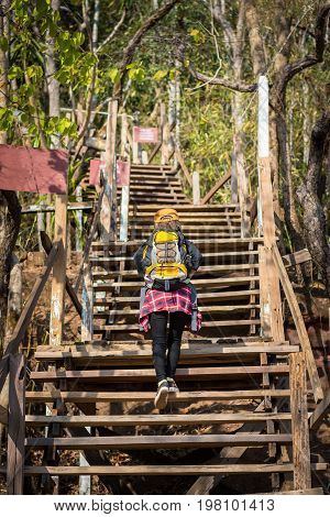 Tourist Young Woman Wearing Hat Enjoying The Walk Up The Stairs On The Mountain.