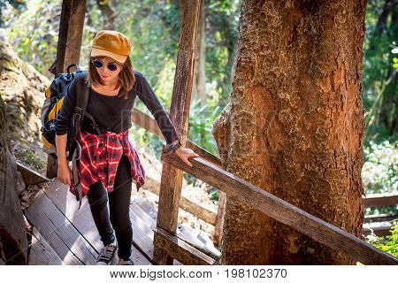 Tourist Young Woman Wearing Hat Enjoying The Walk Up The Stairs On The Mountain.