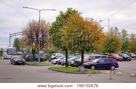 Cars At Parking Lot In Autumn