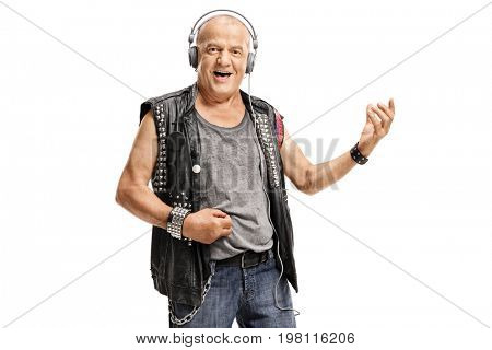 Elderly punker wearing headphones and playing air guitar isolated on white background