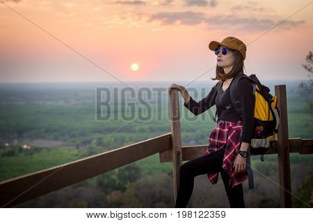 Tourist Young Woman Stand On The Moutain Watching The Beautiful Sunset.