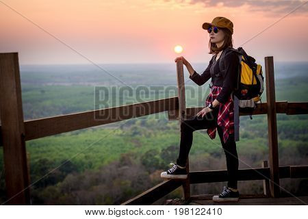 Tourist Young Woman Stand On The Moutain Watching The Beautiful Sunset.