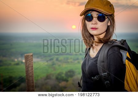 Tourist Young Woman Stand On The Moutain Watching The Beautiful Sunset.