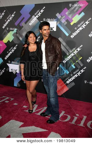 LOS ANGELES - APR 20: Jenna Ushkowitz, John Stamos dospět zahájení z The nový T-Mobile Sidek
