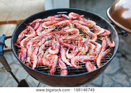 Fresh shrimps Gambos is preparing on grill outdoors