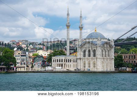 ISTANBUL TURKEY - JUNE 25 2015: Ortaköy Mosque (Grand Imperial Mosque of Sultan Abdulmecid) in Istanbul Turkey is situated at the waterside of the Ortakoy pier square one of the most popular locations on the Bosphorus